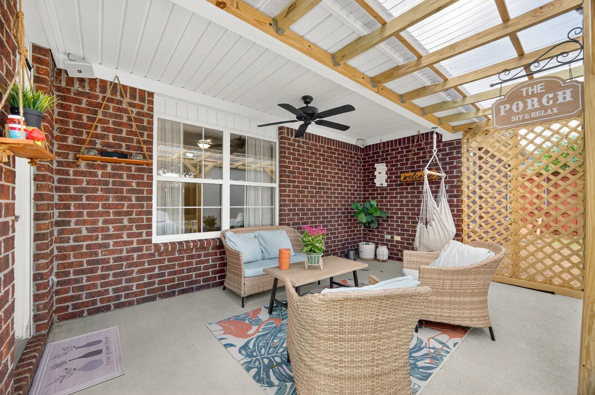 Covered patio at a Meridianville property with seating and a pergola roof