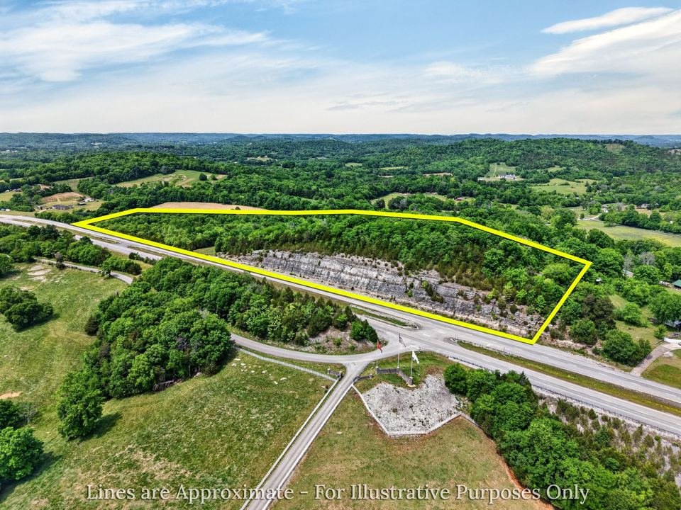 Aerial drone land listing photography with property boundary overlay