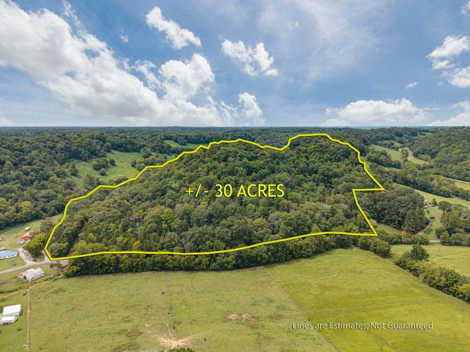 Wooded acreage aerial drone photography with boundary overlay